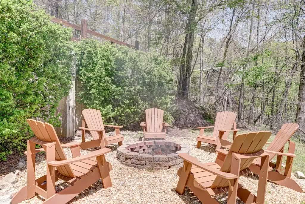 Adirondack chairs gathered around the firepit at dusk